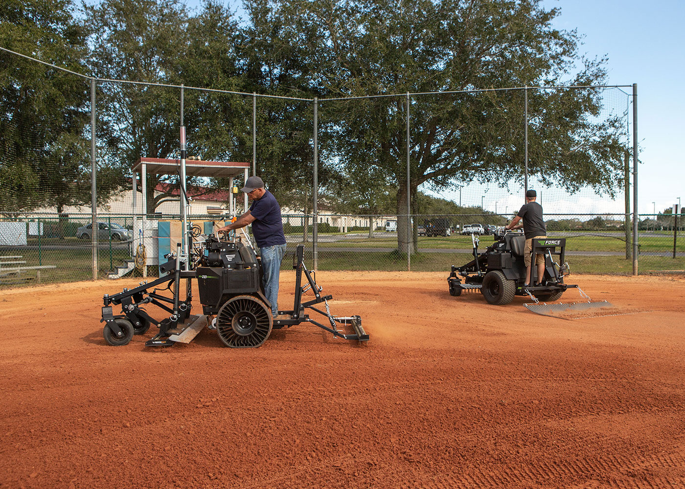 Two baseball field crew members using Force Z-23 on infield