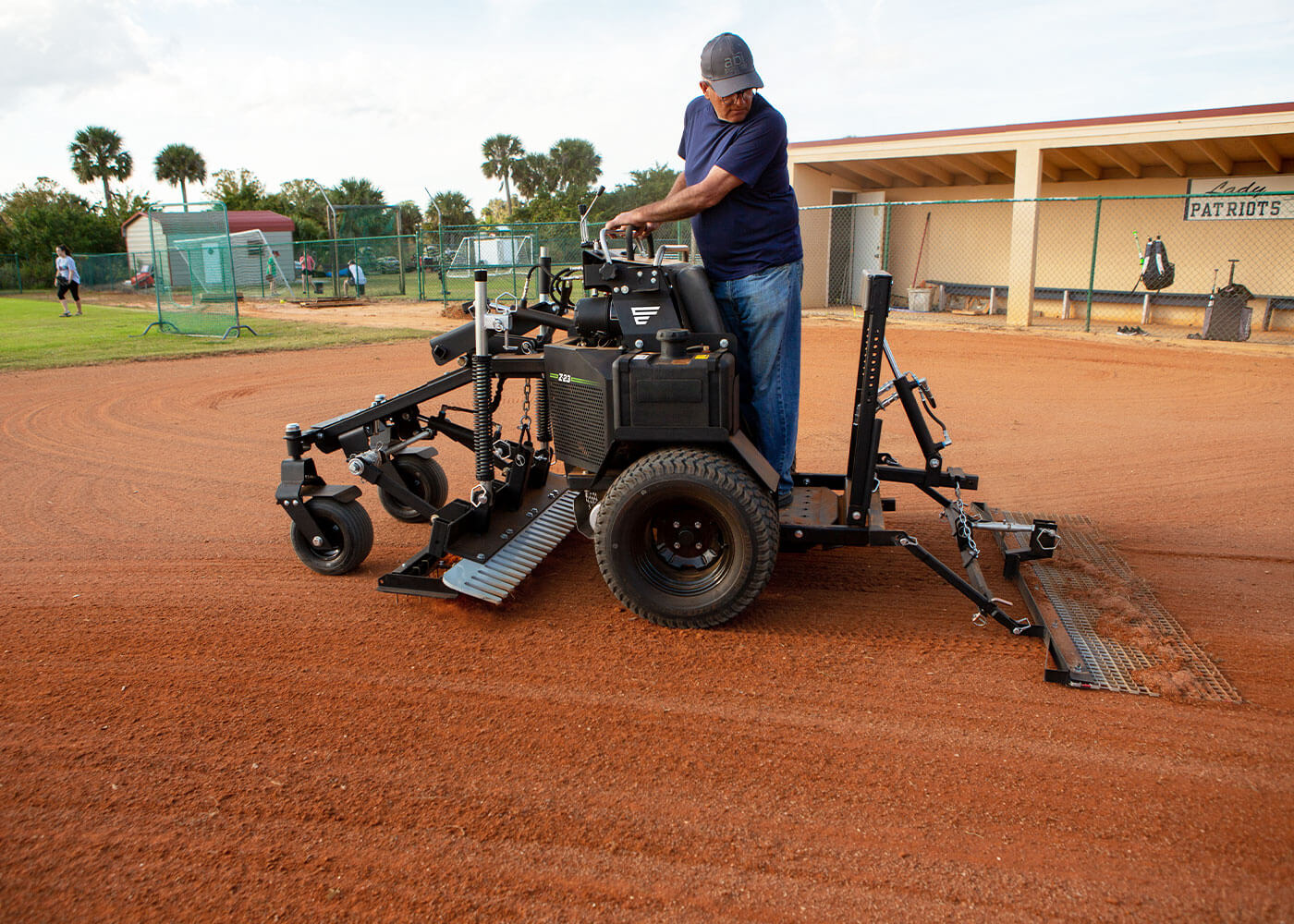 Force laser grader with rigid mat creating safe, playable ballfield 